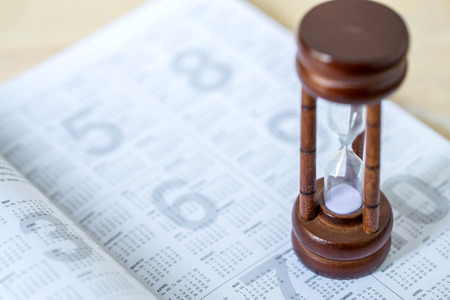 sandglass on calendar timing of diaryの写真素材