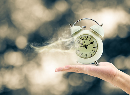 Man holding a clock in his hand And lost time, concept businessの写真素材