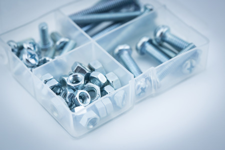 Assorted nuts and bolts closeup in blue toneの写真素材