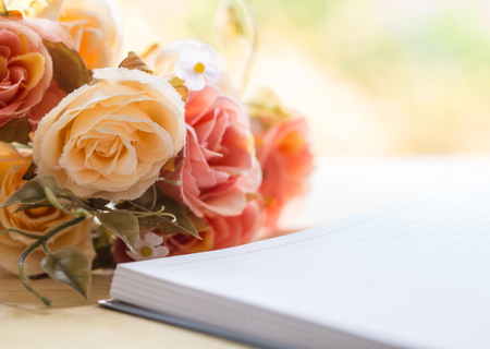 Blank notebook and hearts with flower on wooden table, valentine day conceptの写真素材