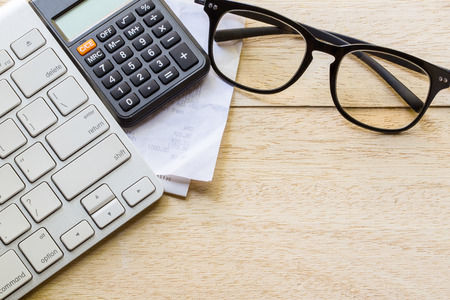 retail online shopping cart icon button on a keyboard, calculator and receipt on tableの写真素材