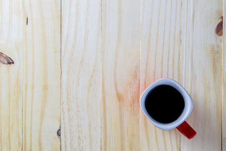 Coffee cup top view on wooden table backgroundの写真素材