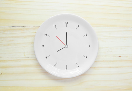 Empty white plate on wood backgroundの写真素材