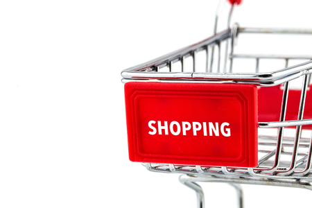 Empty shopping cart with text shopping closeup on white backgroundの写真素材