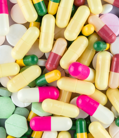 many colored drugs pills shapes texture backgroundの写真素材