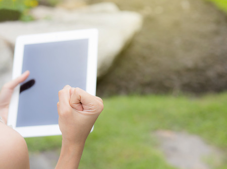 tablet with a blank screen in the hand with successの写真素材