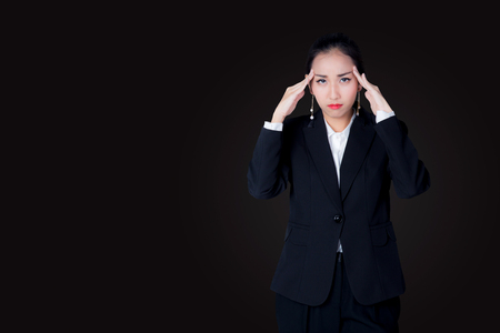A young business woman have stress overworking with suffering from headacheの写真素材