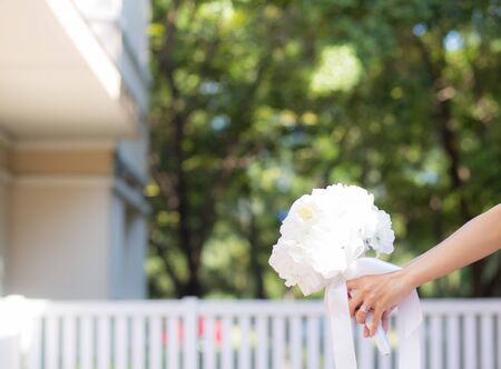 Beautiful wedding bouquet in hands of the brideの写真素材