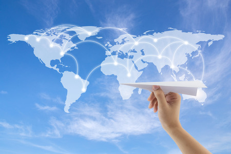 plane in hand with world map on background, Map of flight routes airplanes network use for global...