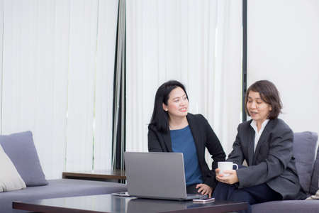 senior and junior businesswoman discuss something during their meeting.の写真素材