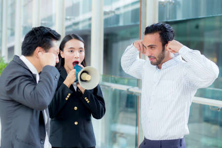 Young business woman working at the office, shouting and yelling in megaphone