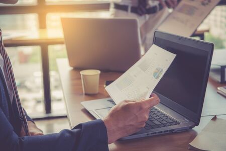 Business team analyzing income charts and graphs. Close up. Business analysis and strategy concept.の写真素材