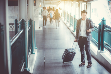 Businessman traveler journey and talking phone with business travel concept.の写真素材