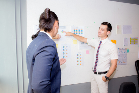 three business people in modern office looking report and analyzing with talking in meeting room.の写真素材