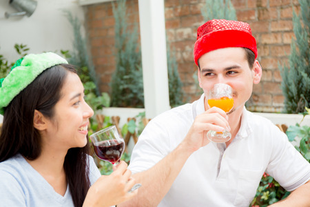 Asian group people drinking at party outdoor. group of friends cocktails in hand with glasses.