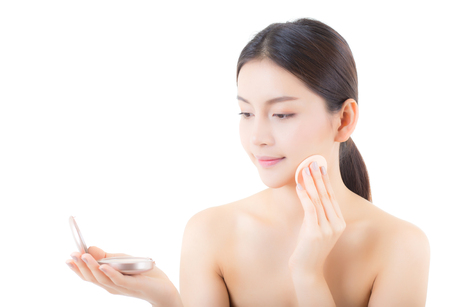 Asian woman beauty applying powder puff at cheek, cosmetics beautiful concept.の写真素材