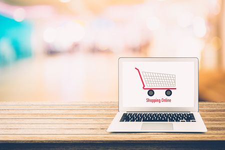 shopping online with labtop, notebook on table top and bokeh background, shop with computer.の写真素材