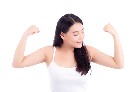 Portrait of beautiful asian woman power strong and strength, beauty of girl with wellness and smile isolated on white background, healthcare concept.の写真素材