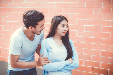 Portrait of couple asian young woman and man outdoor with relationship problem together, emotion unhappy concept.の写真素材