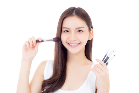 Beauty asian woman applying make up with brush of cheek isolated on white background, beautiful of girl holding blusher, skincare and cosmetic concept.の写真素材