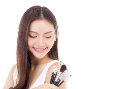 Beauty asian woman applying make up with brush on hand isolated on white background, beautiful of girl holding blusher, skincare and cosmetic concept.の写真素材