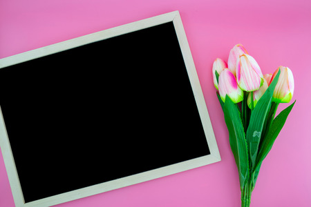 Beautiful of yellow tulip flower and chalkboard, blackboard with flat lay on the pink background,...
