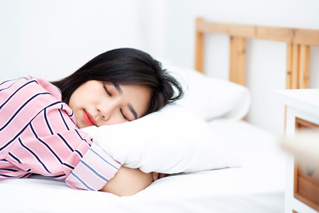 Portrait of beautiful asian young woman sleep lying in bed with head on pillow comfortable and happy with leisure, girl with relax  for health and lifestyle concept.の写真素材