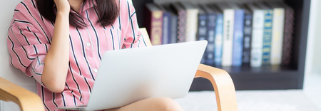 Banner website asian young woman working online laptop with smile and happy sitting on chair at...