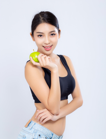 Portrait asian woman smiling holding green apple fruit and beautiful body diet with fit isolated on white background, girl weight slim with cellulite or calories, health and wellness concept.の写真素材