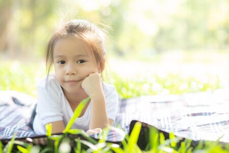 Portrait face of cute asian little girl and child happiness and fun in the park in the summerの写真素材