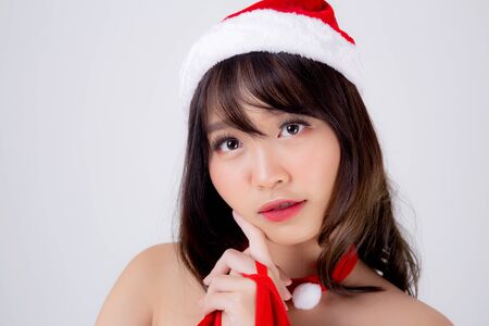 Beautiful portrait young asian woman Santa costume wear hat smiling with happy in holiday xmasの写真素材