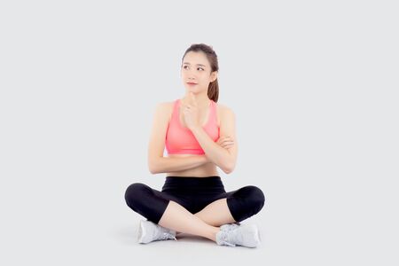 Beautiful portrait young asian woman in sport with satisfied and confident thinking idea isolated on white background, asia girl sitting exercise for fit with healthy, health and wellness concept.の写真素材