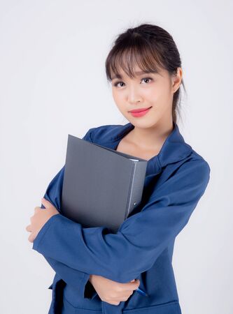 beautiful portrait young business asian woman cheerful standing holding folder isolated on white background, asia businesswoman confident secretary work holding document file with success.の写真素材