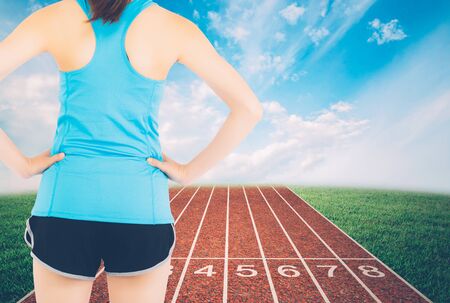 Back young asian woman start a run with track and nature background, girl runner ready to target...