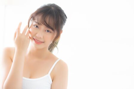 Portrait of beautiful young asian woman smile healthy and wellness at the bedroom, beauty asia girl skin care touch eye makeup and cosmetic with happy with fresh, lifestyle and relax concept.の写真素材