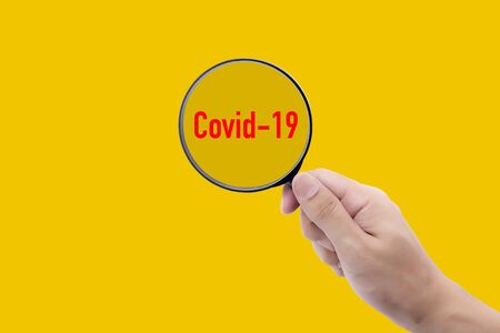 Covid-19 is outbreak while search people with infection with magnifying glassの写真素材