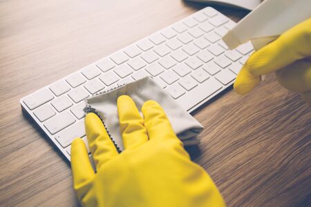Hand of man cleaning keyboard computer using antiseptic alcohol cleanの写真素材