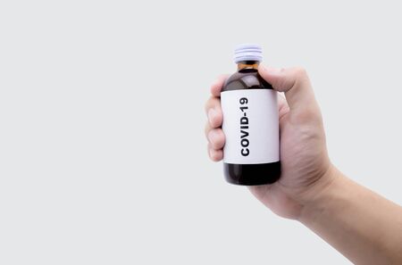 Hand holding sample medicine for covid-19