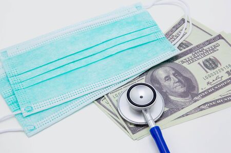 Stethoscope on dollar banknote isolated on white