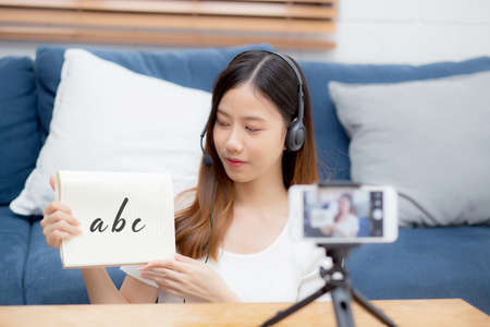 Young asian woman is teacher teaching language english with student for e-learning online at home,...