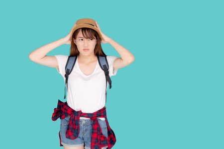 Beautiful young asian woman upset and worry travel summer trip in abroad isolated on blue background, tourist asia girl having problem and stress journey in vacation for leisure, holiday concept.の写真素材
