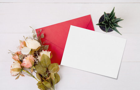 Valentine day, greeting card mockup and letter and flower on wooden table, postcard blank and gift with romance on desk, present in anniversary and celebration, top view, holiday concept.の写真素材