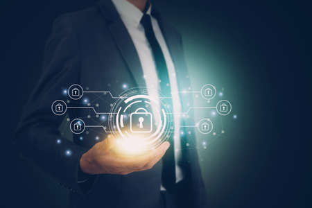 Hand of businessman holding virtual lock icon while cyber security, access data and privacy with protection digital, innovation of system protect for identity, business futuristic concept.の写真素材