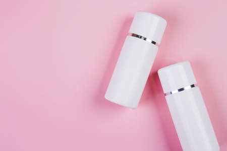 Mockup cosmetic bottle with cream or lotion isolated on pink background, mock up package for...