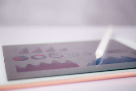 Report graph and chart of investment with finance on tablet computer on desk, datum of stock and...