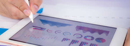 Businessman planning about graph and chart of investment with report for finance on tablet computer...