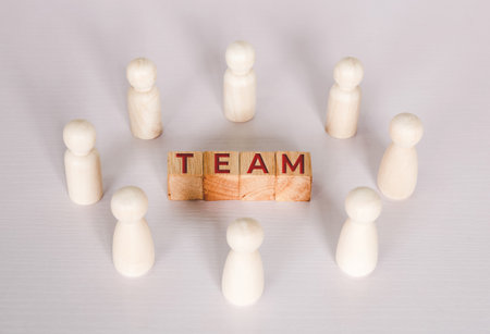 Word team on wooden block, relationship of collaboration and leadership for success, group of community and employee with corporate, teamwork for brainstorming together, no people, business concepts.の写真素材