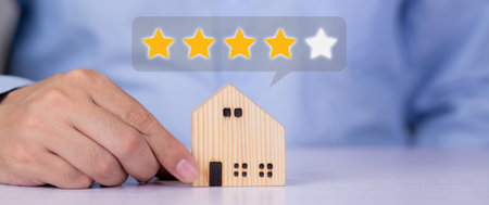 Hands of businessman holding home model with choice for satisfaction and score of guarantee and vote, review and feedback of property, survey and rating, investment of real estate business concepts.の写真素材