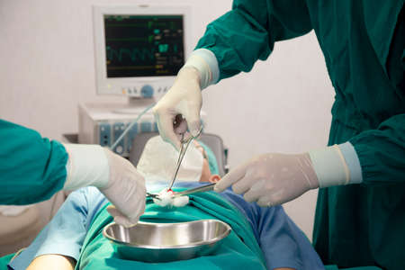 Closeup hands of team doctor and surgeon doing surgery with patient in the operation at hospital,...