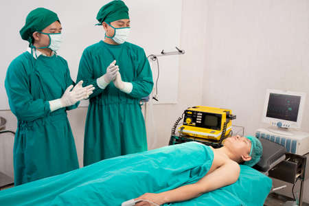 Doctor and surgeon preparation with rescue and  save patient in the operation room at hospital,...